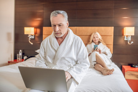 Couple in bath robes spending a day together and feeling relaxedの写真素材