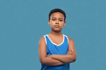 Serious boy in sports blue shirtの写真素材