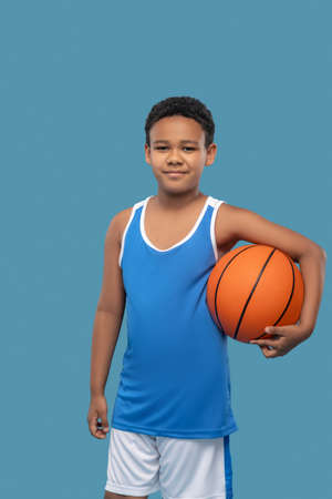 African american sports schoolboy with basketballの写真素材