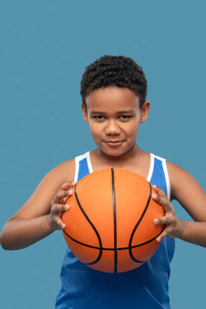Attentive boy taking aim with ball in handsの写真素材
