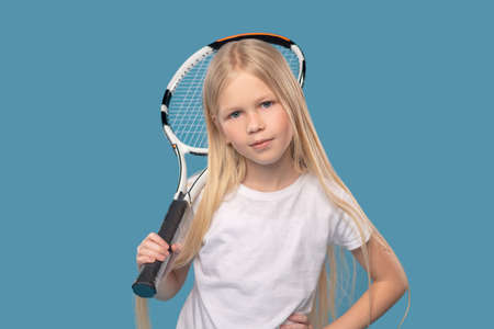 Overconfident elementary school girl with tennis racketの写真素材