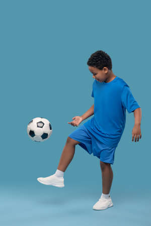 African american elementary school boy playing soccerの写真素材