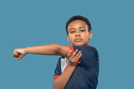 Serious african american boy exercising handsの写真素材