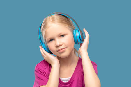 Happy blonde cute girl in headphonesの写真素材