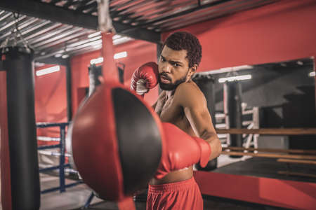 African american kickboxer having a workout in a gym and looking concentratedの写真素材