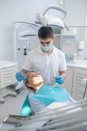 Dentist working on patients teeth restoration and making dental fillingの写真素材