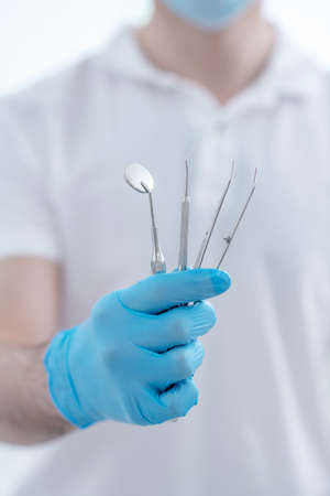 Close up pictire of doctors hands with dental medical toolsの写真素材