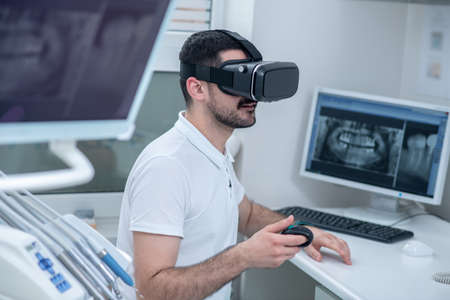 Picture of a man in vr glasses looking involvedの写真素材