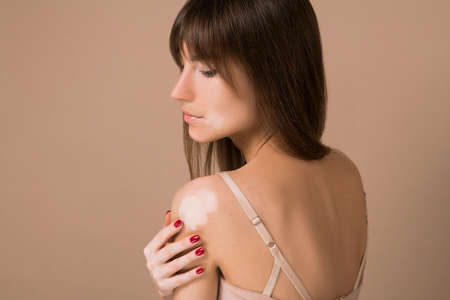 A waist up picrture of young pretty long-haired woman with skin pigmentationの写真素材
