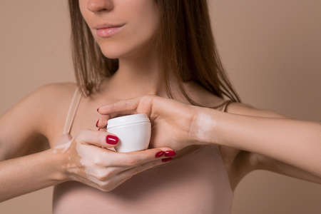A slim long-haired beautiful woman in beige lingerieの写真素材