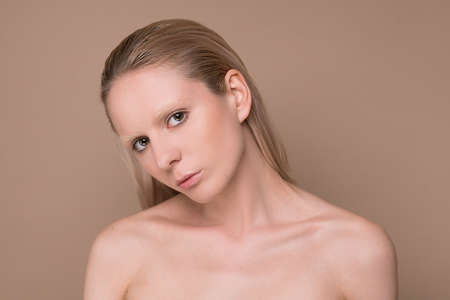 A waist up picture of a blonde young womanの写真素材