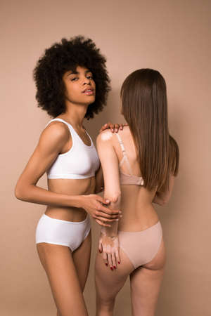 Two young beautiful women in lingerie hugging each otherの写真素材