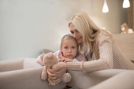 Mom and her daughter waiting for the appointment at the clinicの写真素材