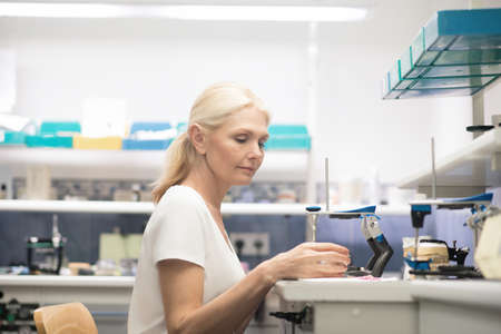 Prosthetist. A female prothetist working with plaster prosthesisの写真素材