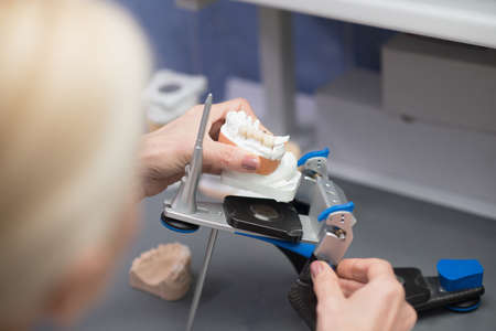 Prosthetist working with equipment at the dental clinicの写真素材