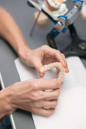 Dental prothetist. Close up picture of hands with dental prosthesisの写真素材