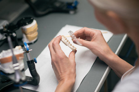 Close up picture of hands with dental prosthesisの写真素材
