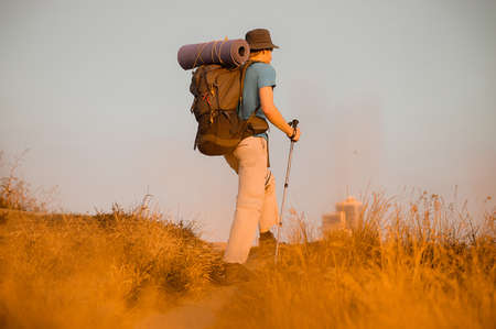 A male hiker enjoying view of nature from the hill