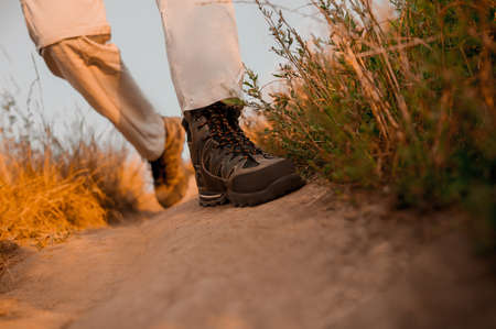 Close up of a man walking on a footpathの写真素材