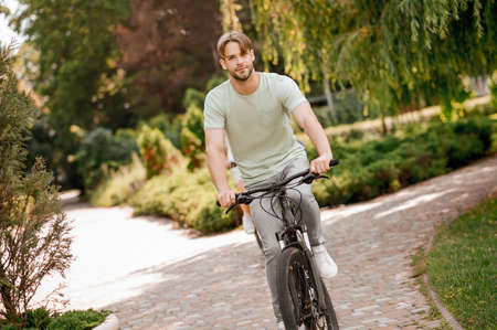 Handsome Caucasian sportsman biking in the morningの写真素材