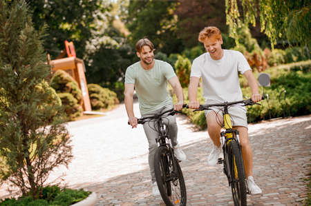 Two friends enjoying their morning cycling workoutの写真素材