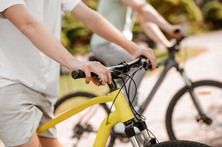 Two Caucasian athletes biking together in a park