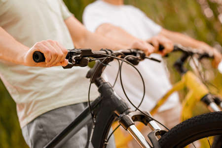 Athletic Caucasian men with their bicycles outdoorsの写真素材