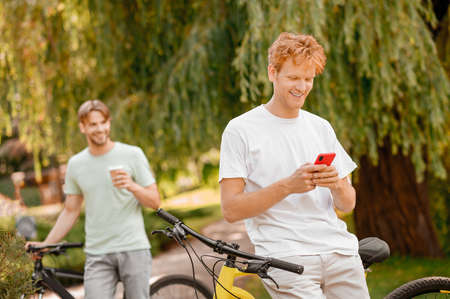 Two bicyclists enjoying their coffee break outdoorsの写真素材