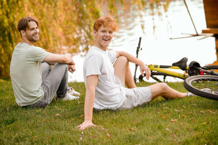 Two cyclists resting after the cycling workoutの写真素材