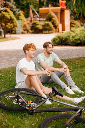 Two sporty pals resting after the outdoor cycling workoutの写真素材