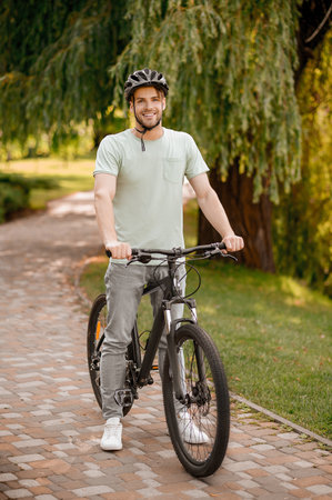 Smiling attractive cyclist in a local parkの写真素材