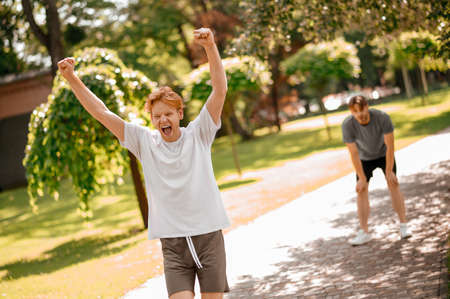 Guy rejoicing at victory in running competitionの写真素材
