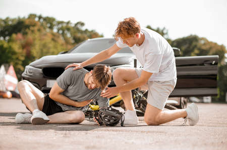 Ginger guy supporting an injured cyclist