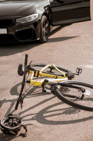 Accident on road with car and bikeの写真素材
