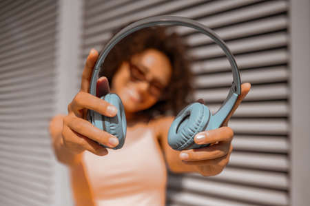 A young woman with headphones looking enjoyed and feeling goodの写真素材