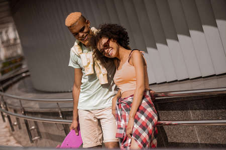 Young dark-skinned couple enjoying the day togetherの写真素材
