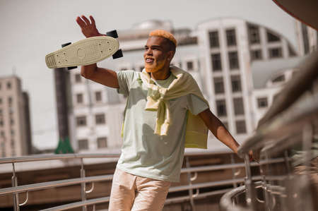 Young good-looking man with dyed hair looking confidentの写真素材