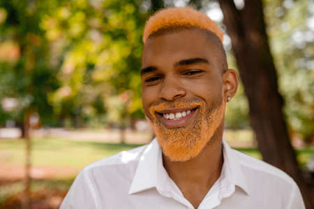 Young man in white clothes in the parkの写真素材