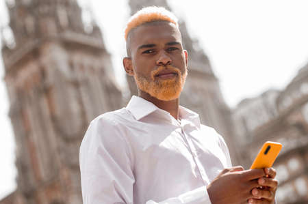 Handsome and elegant young man with a smartphoneの写真素材