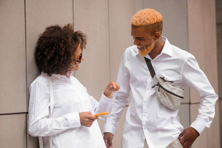 A couple standing near the wall and talkingの写真素材