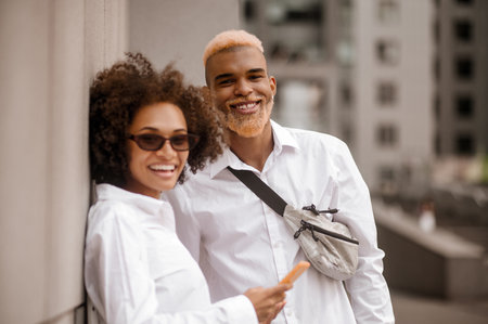 A couple standing near the wall and talkingの写真素材