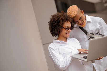 Two colleagues discussing something and looking involvedの写真素材