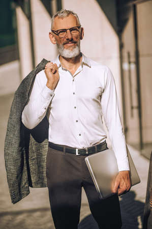 Calm business person with the laptop looking aheadの写真素材