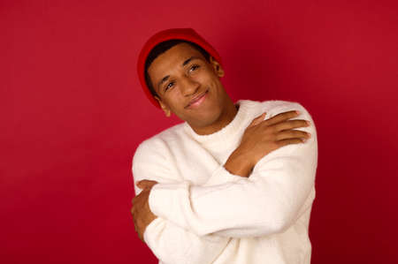 Dark-skinned young man in a santa hatの写真素材
