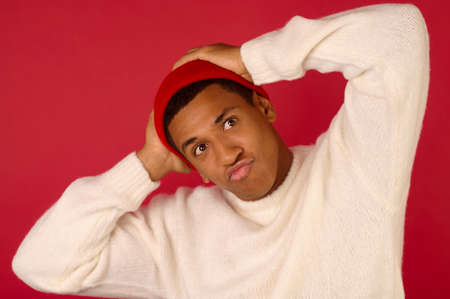 An african american guy in white sweater in sanat hatの写真素材
