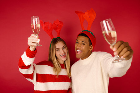 Young people in horned hats celebrating christmasの写真素材