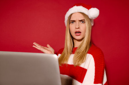 A girl in a santa hat with a laptopの写真素材