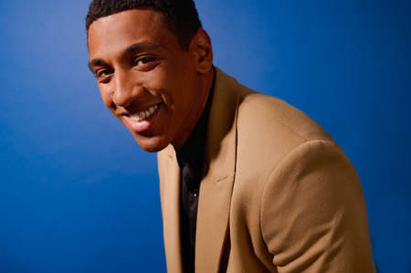 A good-looking mulatto in a beige suitの写真素材