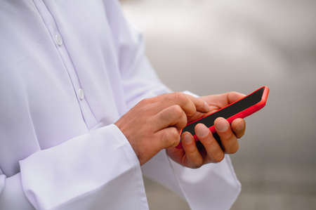 Arabian man with a smartphone in handsの写真素材