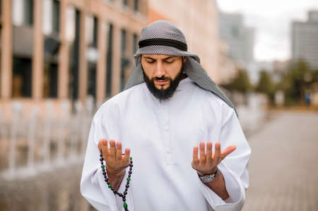 Young bearded arabian guy doing namazの写真素材